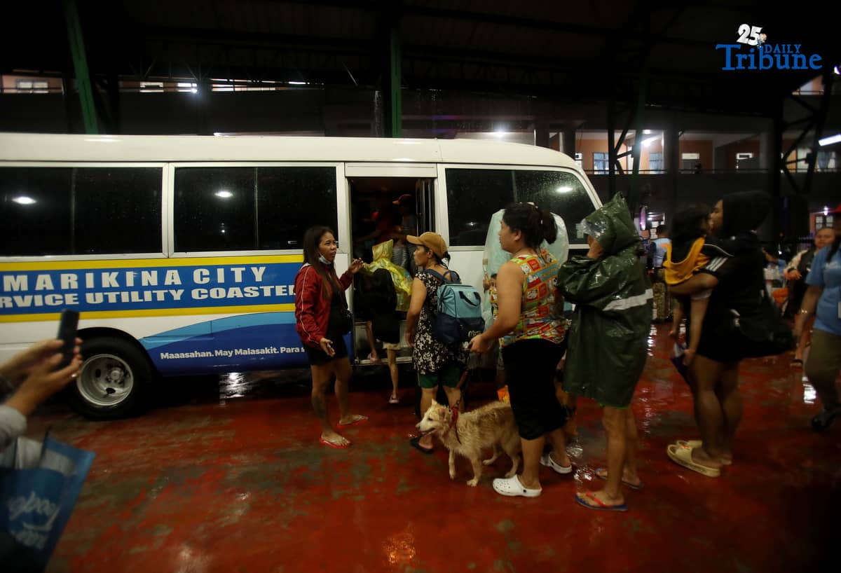Residents living near the Marikina River arrive at H. Bautista Elementary School in Marikina City after evacuating their homes on 9 November 2025, as a preemptive measure ordered by the local government ahead of Super Typhoon Uwan.