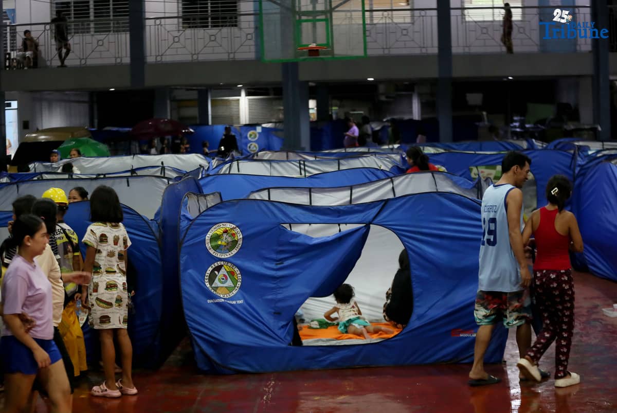 Residents living near the Marikina River arrive at H. Bautista Elementary School in Marikina City after evacuating their homes on 9 November 2025, as a preemptive measure ordered by the local government ahead of Super Typhoon Uwan.