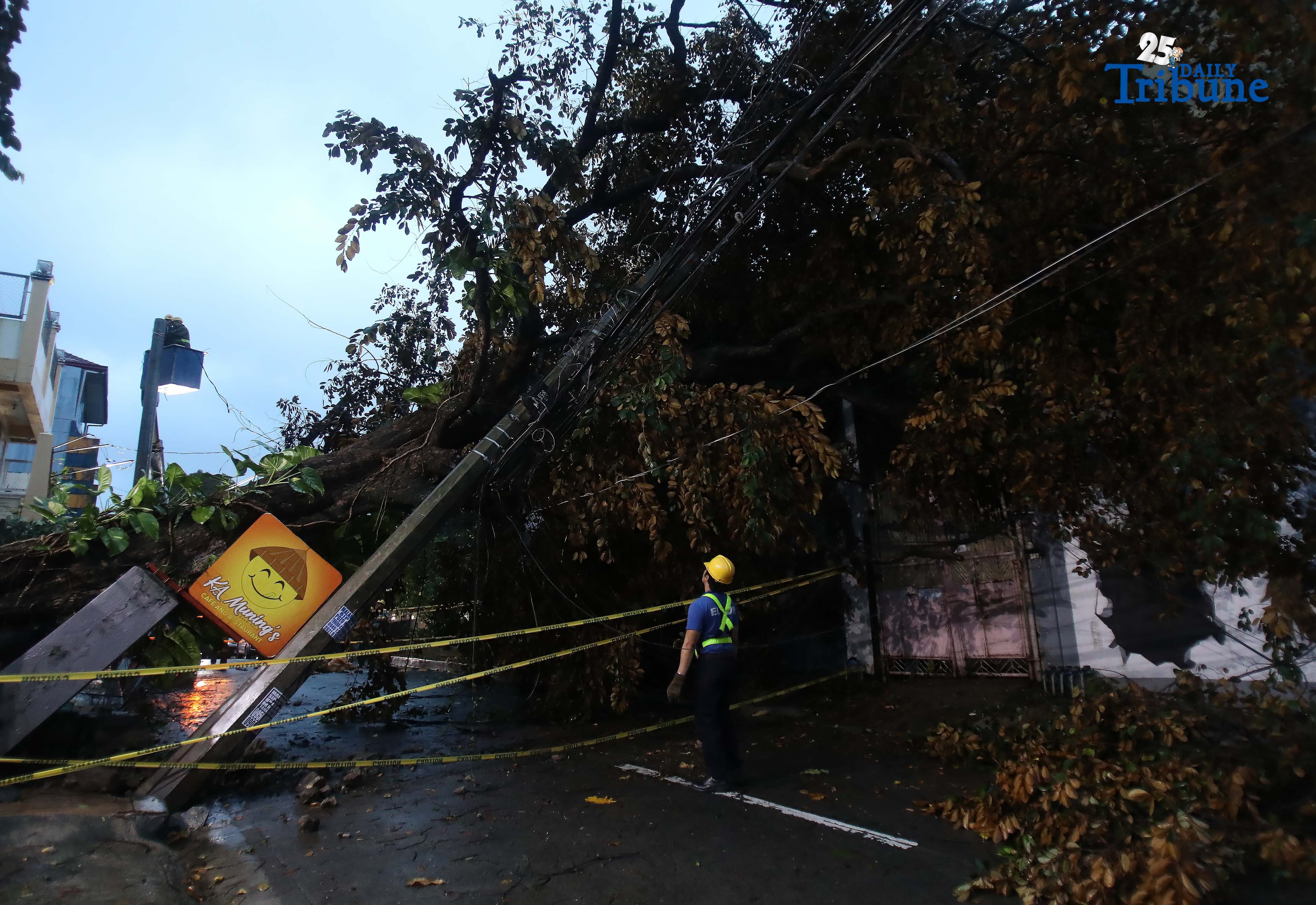 Meralco crews repair toppled electric post in Quezon City amid Uwan