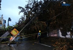 Meralco crews repair toppled electric post in Quezon City amid Uwan