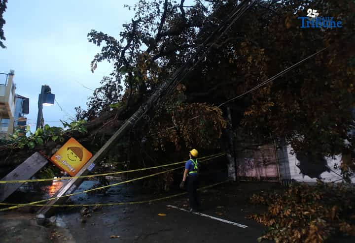 Meralco crews repair toppled electric post in Quezon City amid Uwan