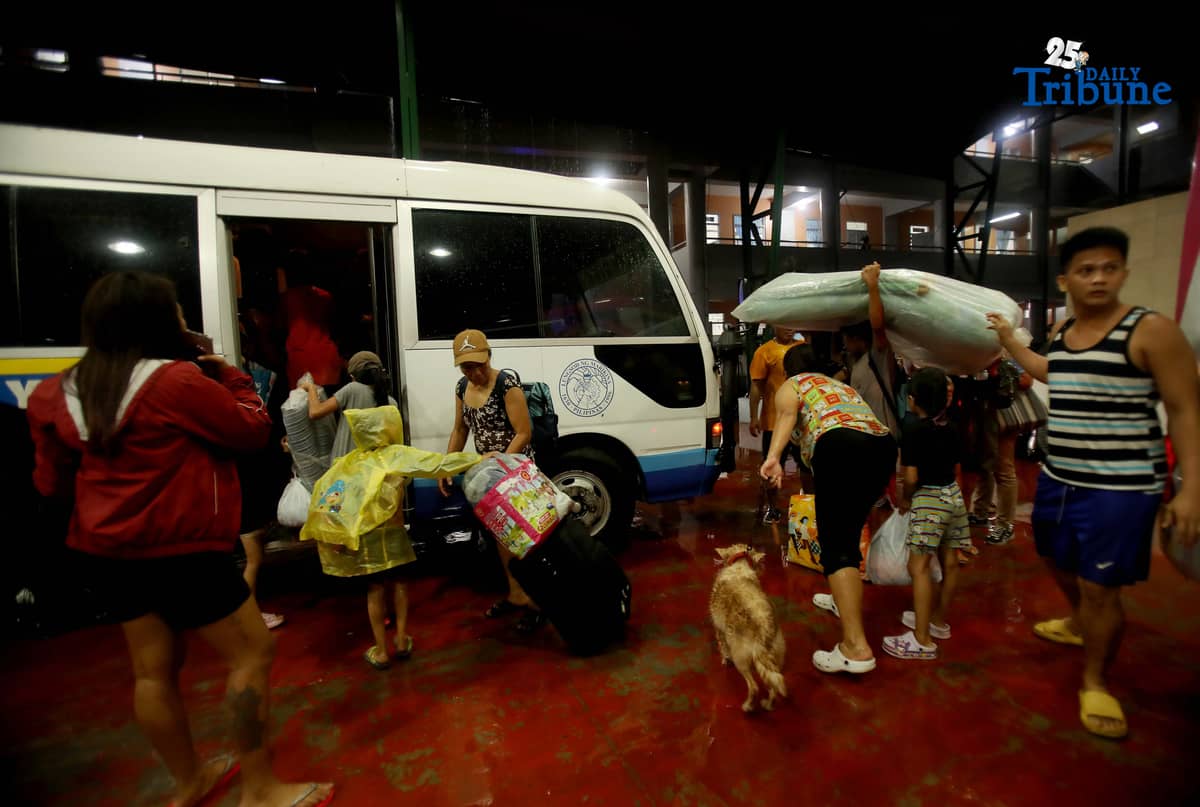 Residents living near the Marikina River arrive at H. Bautista Elementary School in Marikina City after evacuating their homes on 9 November 2025, as a preemptive measure ordered by the local government ahead of Super Typhoon Uwan.