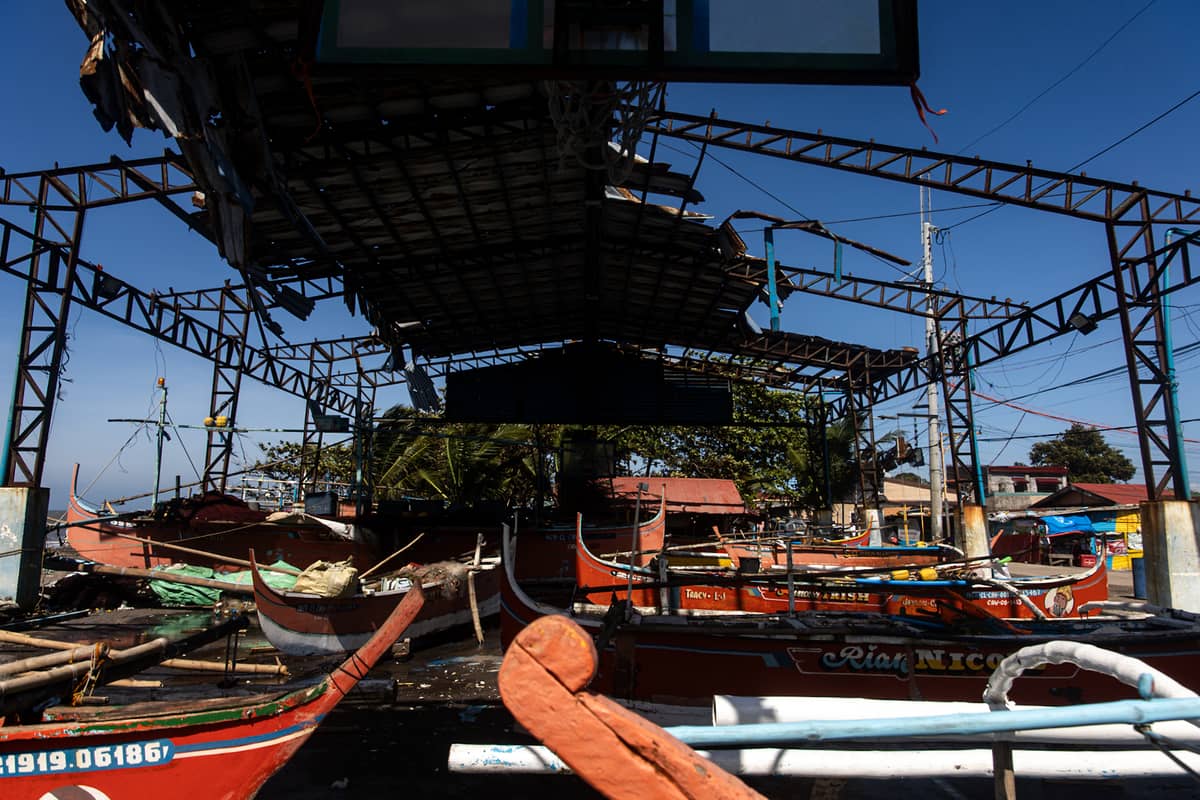 Boats are docked inside a destroyed basketball court in the coastal barangay Julugan 8 in Tanza, Cavite on Tuesday.
