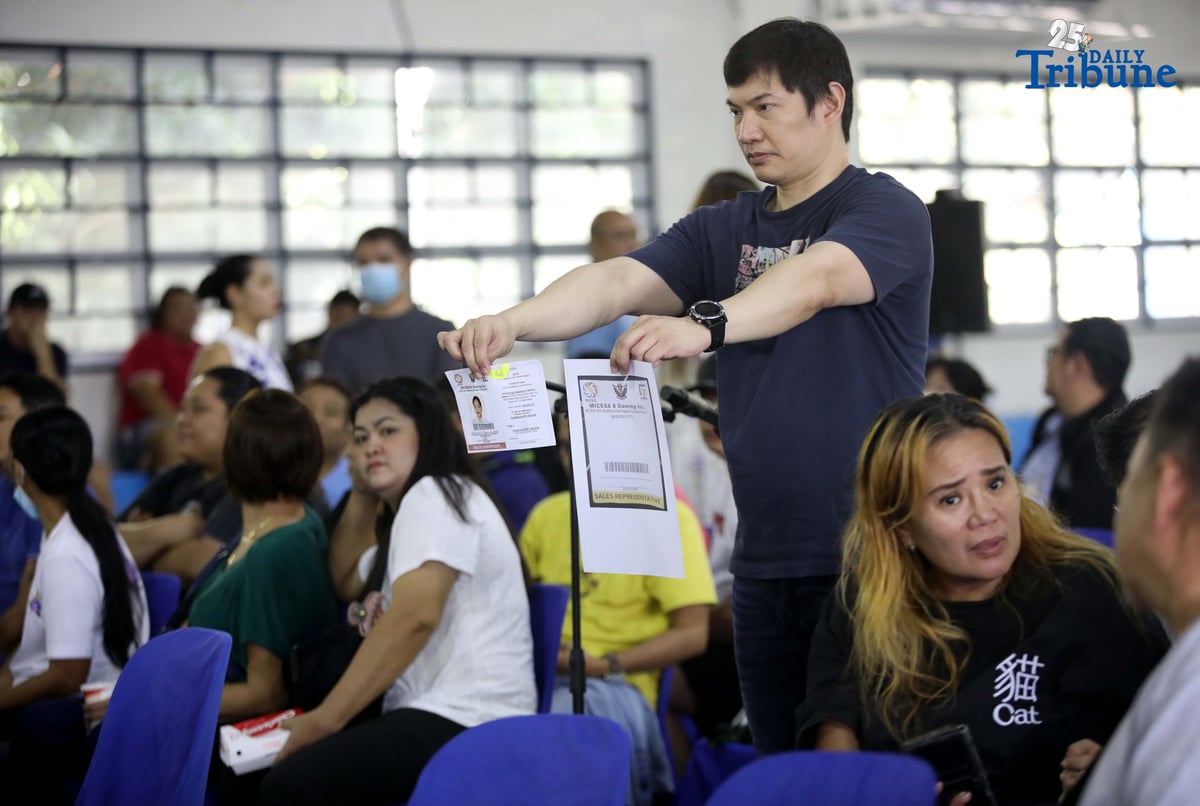 Carlos Montemayor, owner of Micesa 8 Gaming Inc., meets with Small Town Lottery (STL) agents at Camp Karingal in Quezon City, presenting samples of genuine versus fake STL identification cards. Montemayor and STL officials urged closer coordination with local authorities and the police to curb illegal number games such as “jueteng,” and reaffirmed full compliance with PCSO rules to safeguard bettors and STL players.