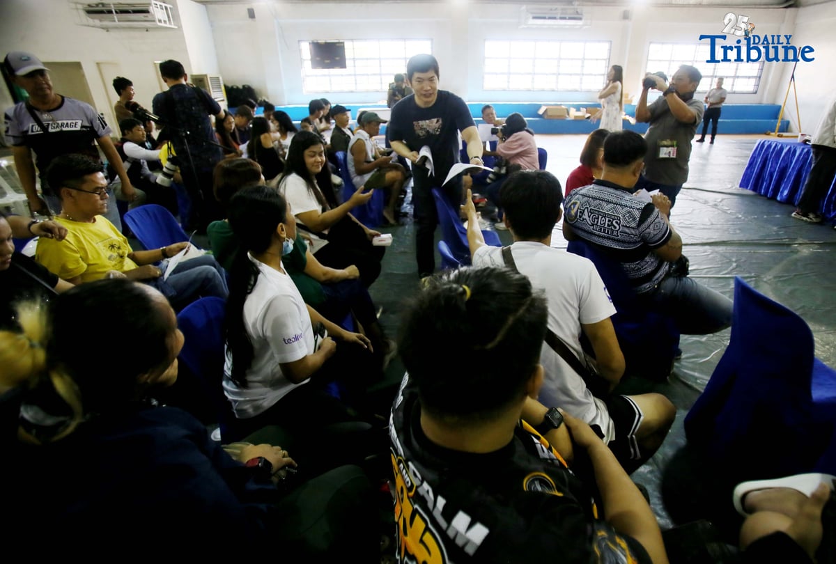 Carlos Montemayor, owner of Micesa 8 Gaming Inc., meets with Small Town Lottery (STL) agents at Camp Karingal in Quezon City, presenting samples of genuine versus fake STL identification cards. Montemayor and STL officials urged closer coordination with local authorities and the police to curb illegal number games such as “jueteng,” and reaffirmed full compliance with PCSO rules to safeguard bettors and STL players.