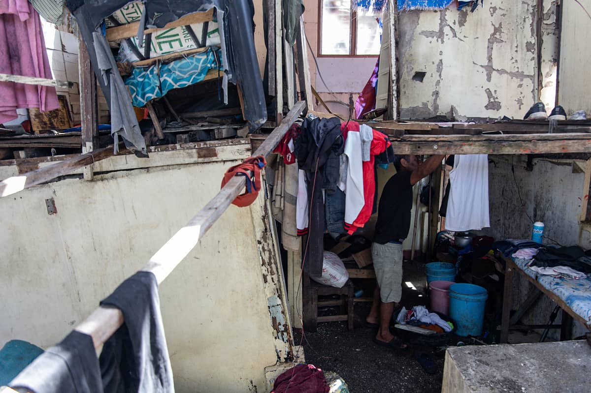 Larry Gonzales, 54, hangs his washed clothes inside his destroyed house caused by Super Typhoon Uwan in the coastal barangay Amaya V, Tanza, Cavite on Tuesday.