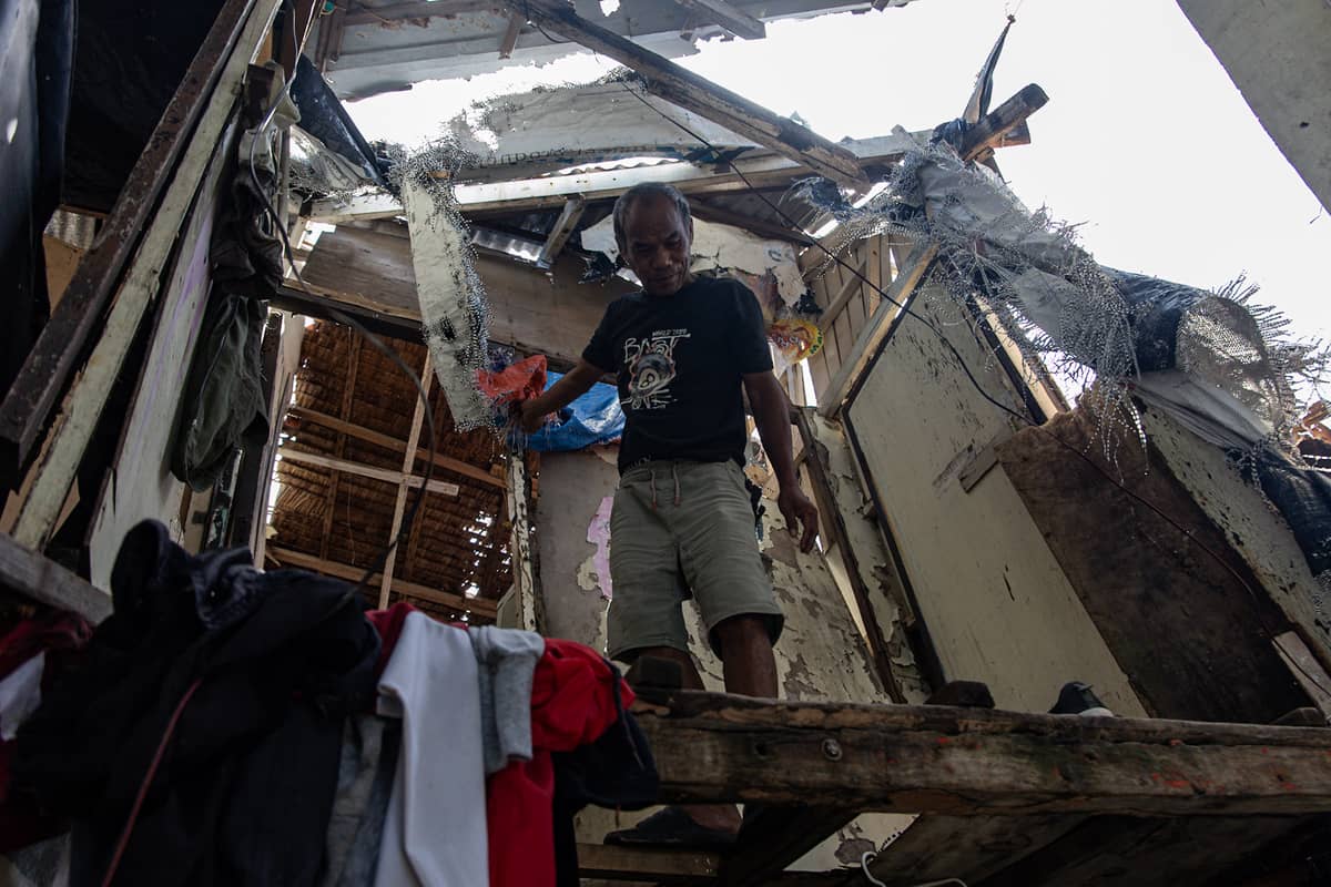 Larry Gonzales, 54, inspects his house that was destroyed by Super Typhoon Uwan in the coastal barangay Amaya V in Tanza, Cavite on Tuesday.
