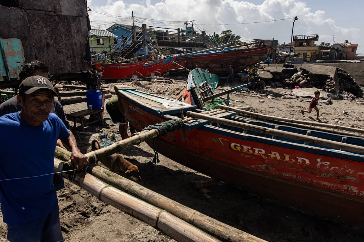 Fishermen make repair on their boats in the aftermath of Super Typhoon Uwan in the coastal barangay Amaya V in Tanza, Cavite on Tuesday.