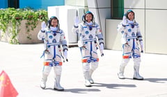 3 astronauts defy space peril
aboard debris-damaged craft