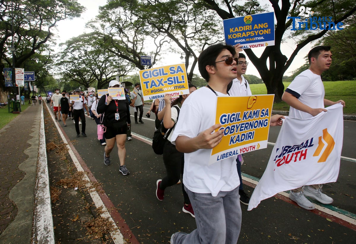 Student Youth Against Kurakot members march around the University of the Philippines–Diliman academic oval in celebration of International Students’ Day, holding placards bearing a symbolic “guilty verdict” against government officials linked to the flood control scandal. The youth group called for accountability and reforms as they staged their protest on campus in Quezon City on Monday.