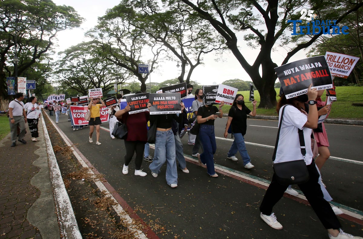 Student Youth Against Kurakot members march around the University of the Philippines–Diliman academic oval in celebration of International Students’ Day, holding placards bearing a symbolic “guilty verdict” against government officials linked to the flood control scandal. The youth group called for accountability and reforms as they staged their protest on campus in Quezon City on Monday.