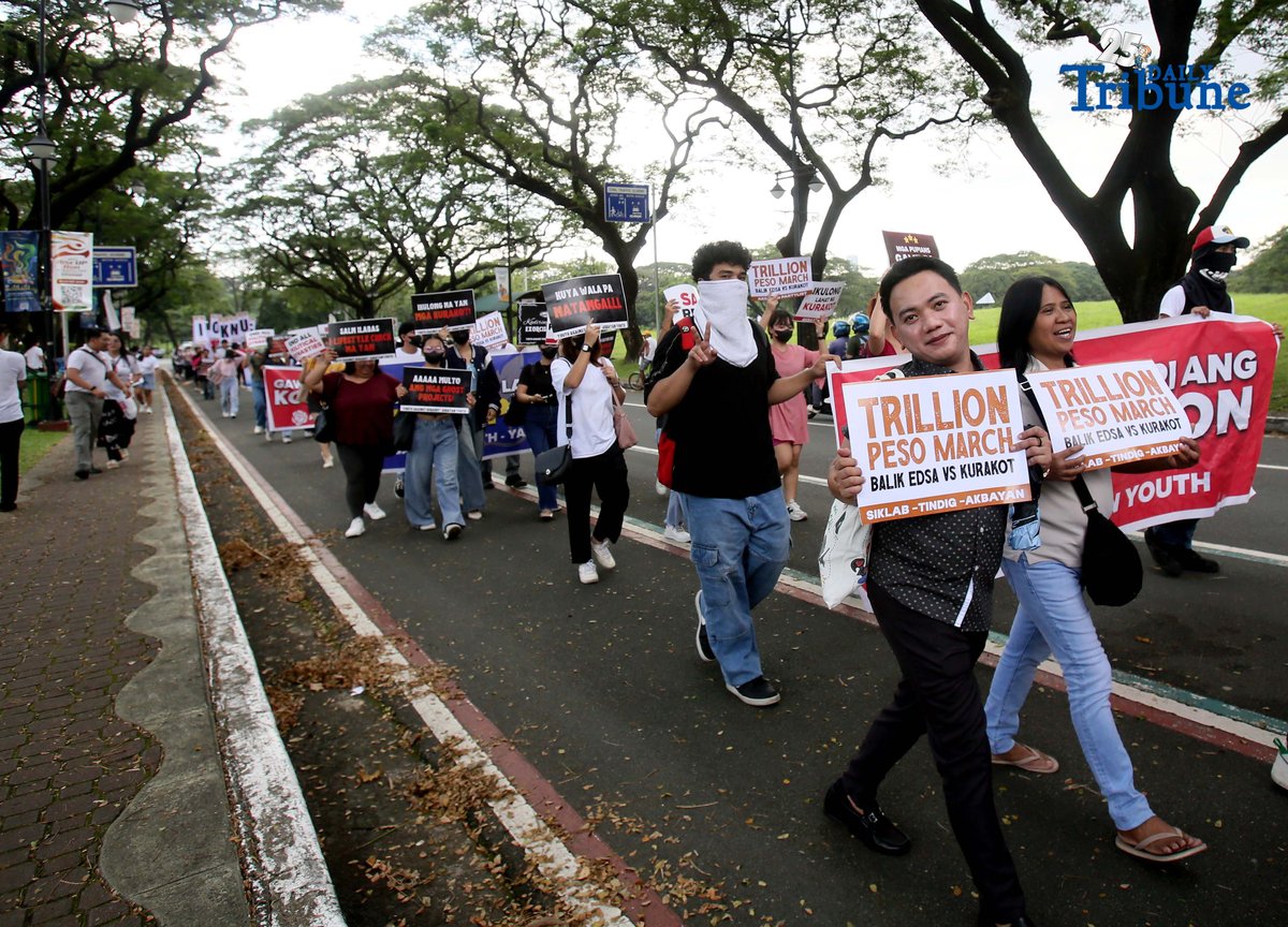 Student Youth Against Kurakot members march around the University of the Philippines–Diliman academic oval in celebration of International Students’ Day, holding placards bearing a symbolic “guilty verdict” against government officials linked to the flood control scandal. The youth group called for accountability and reforms as they staged their protest on campus in Quezon City on Monday.