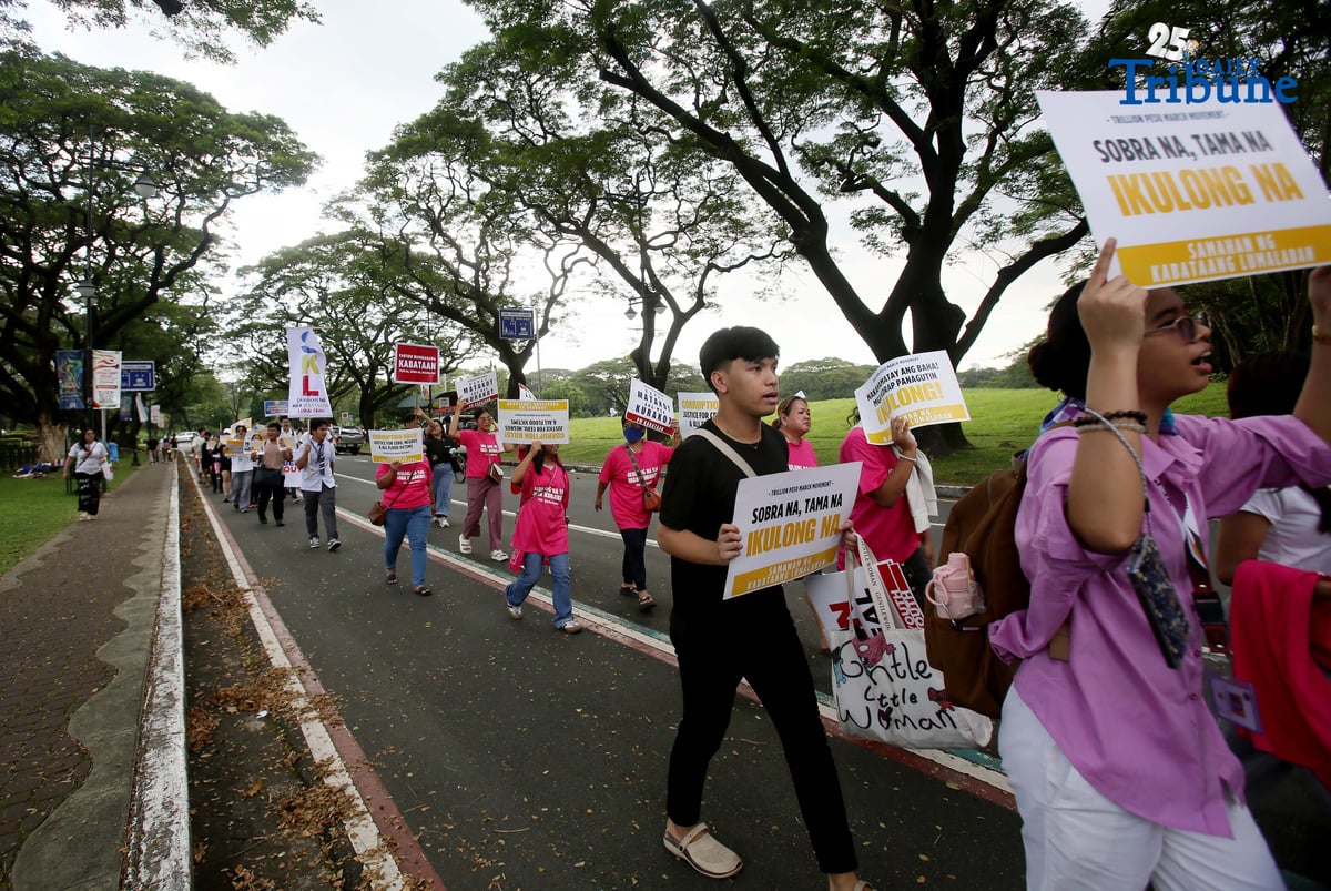 Student Youth Against Kurakot members march around the University of the Philippines–Diliman academic oval in celebration of International Students’ Day, holding placards bearing a symbolic “guilty verdict” against government officials linked to the flood control scandal. The youth group called for accountability and reforms as they staged their protest on campus in Quezon City on Monday.