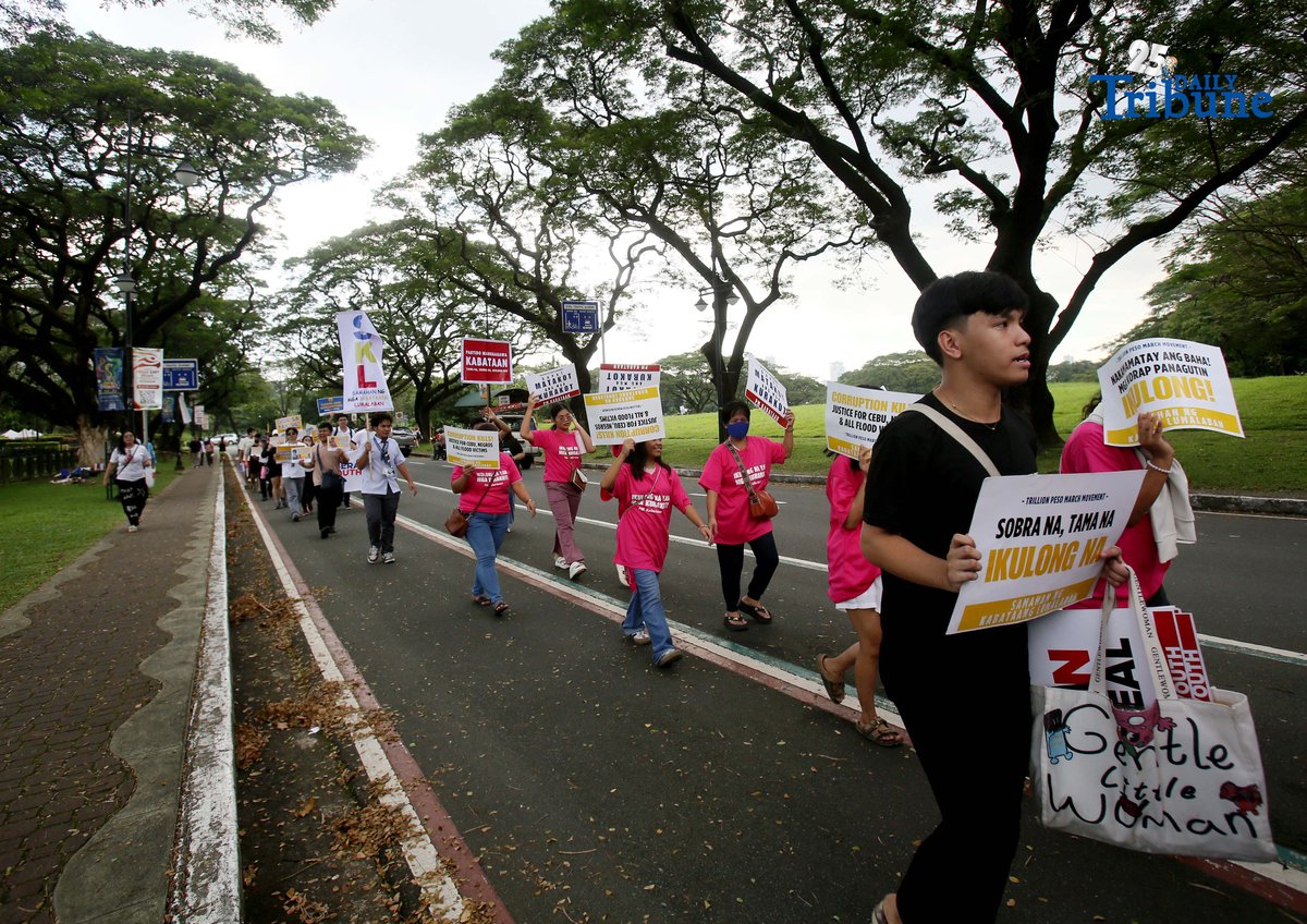 Student Youth Against Kurakot members march around the University of the Philippines–Diliman academic oval in celebration of International Students’ Day, holding placards bearing a symbolic “guilty verdict” against government officials linked to the flood control scandal. The youth group called for accountability and reforms as they staged their protest on campus in Quezon City on Monday.
