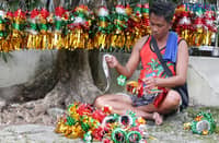 A man sells a Christmas lantern he made himself along NIA Road in Quezon City on 21 November 2025, 34 days before Christmas.