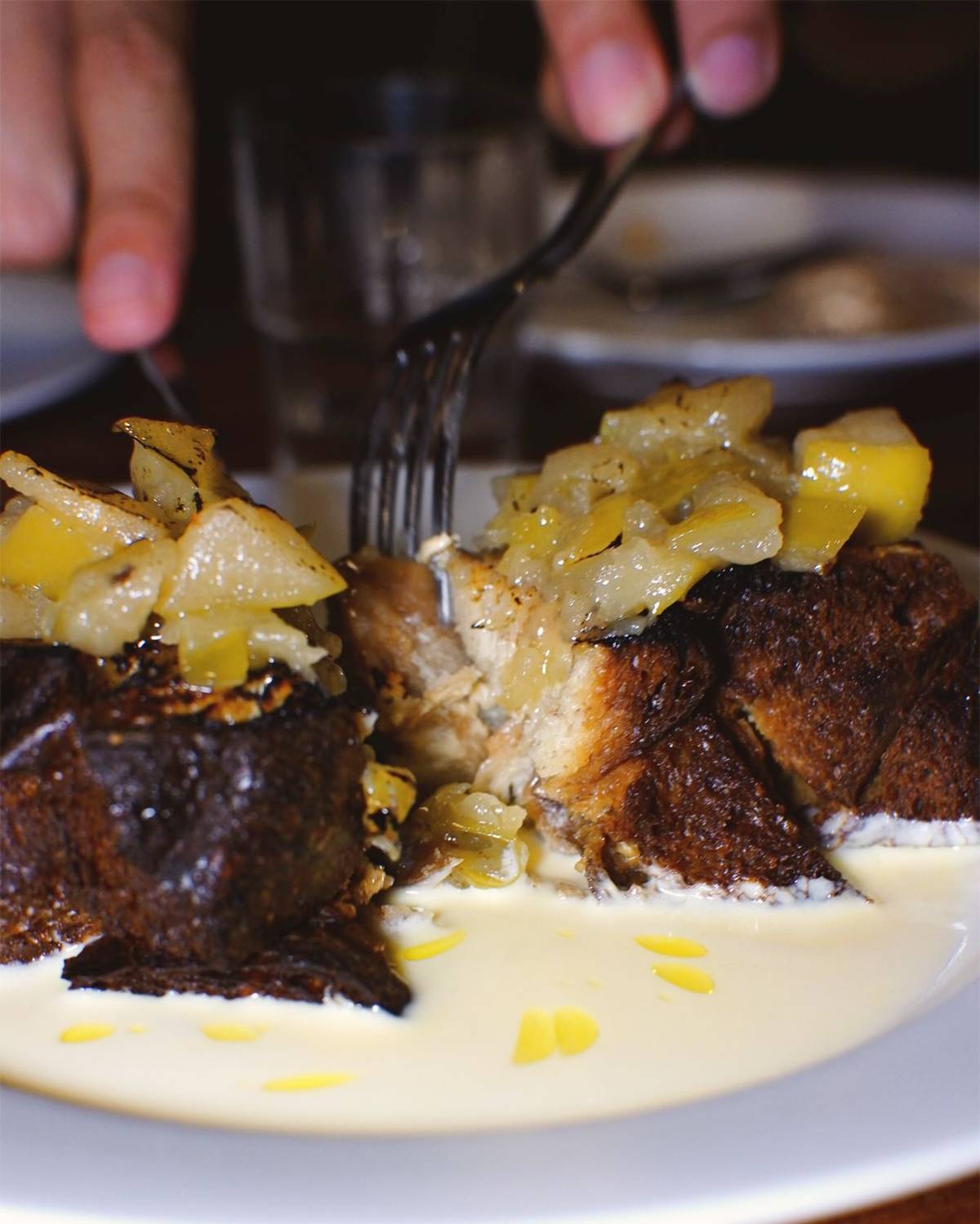 Sourdough Bread Pudding served with silky lemon custard and warm apple stew.