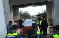 Police officers and security personnel receive a detailed pre-operation briefing at the MMSU campus as authorities tighten security amid a series of bomb threats that disrupted classes and triggered multiple evacuations throughout November 2025. Investigators say digital leads and interagency coordination are steadily closing in on the source of the threats.