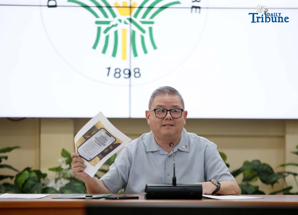 Agriculture Secretary Francisco Tiu Laurel Jr. shows a photocopy of his text exchange with former congressman Zaldy Co — along with a confidential report for Congress — in response to Co’s allegations of “price and import manipulation” of sugar, onion, rice, and fish. Tiu also denied claims that Co influenced the reduction of rice tariffs from 35 percent to 15 percent. The secretary refuted all accusations during a press conference at the Department of Agriculture office in Quezon City on Thursday. Photo by Analy Labor