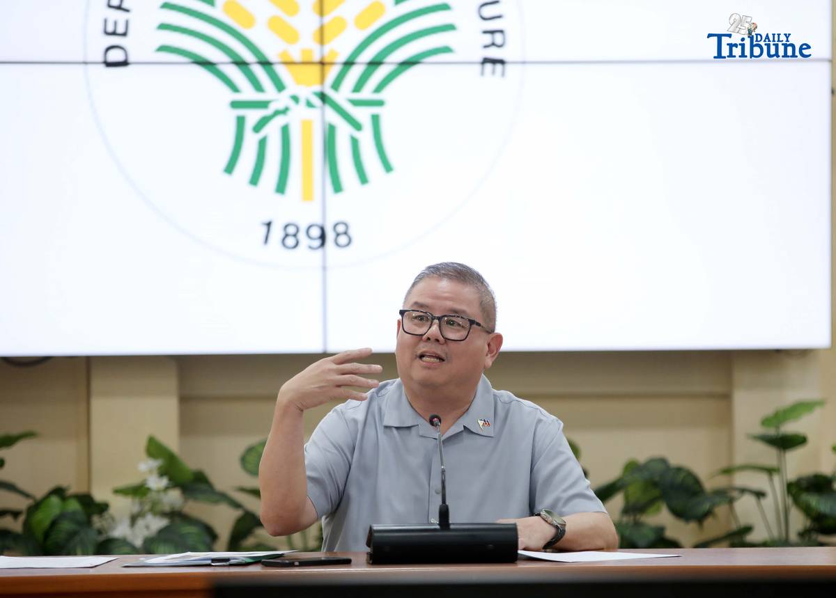 Agriculture Secretary Francisco Tiu Laurel Jr. shows a photocopy of his text exchange with former congressman Zaldy Co — along with a confidential report for Congress — in response to Co’s allegations of “price and import manipulation” of sugar, onion, rice, and fish. Tiu also denied claims that Co influenced the reduction of rice tariffs from 35 percent to 15 percent. The secretary refuted all accusations during a press conference at the Department of Agriculture office in Quezon City on Thursday. Photo by Analy Labor