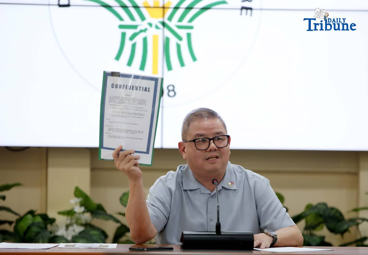 Agriculture Secretary Francisco Tiu Laurel Jr. shows a photocopy of his text exchange with former congressman Zaldy Co — along with a confidential report for Congress — in response to Co’s allegations of “price and import manipulation” of sugar, onion, rice, and fish. Tiu also denied claims that Co influenced the reduction of rice tariffs from 35 percent to 15 percent. The secretary refuted all accusations during a press conference at the Department of Agriculture office in Quezon City on Thursday. Photo by Analy Labor