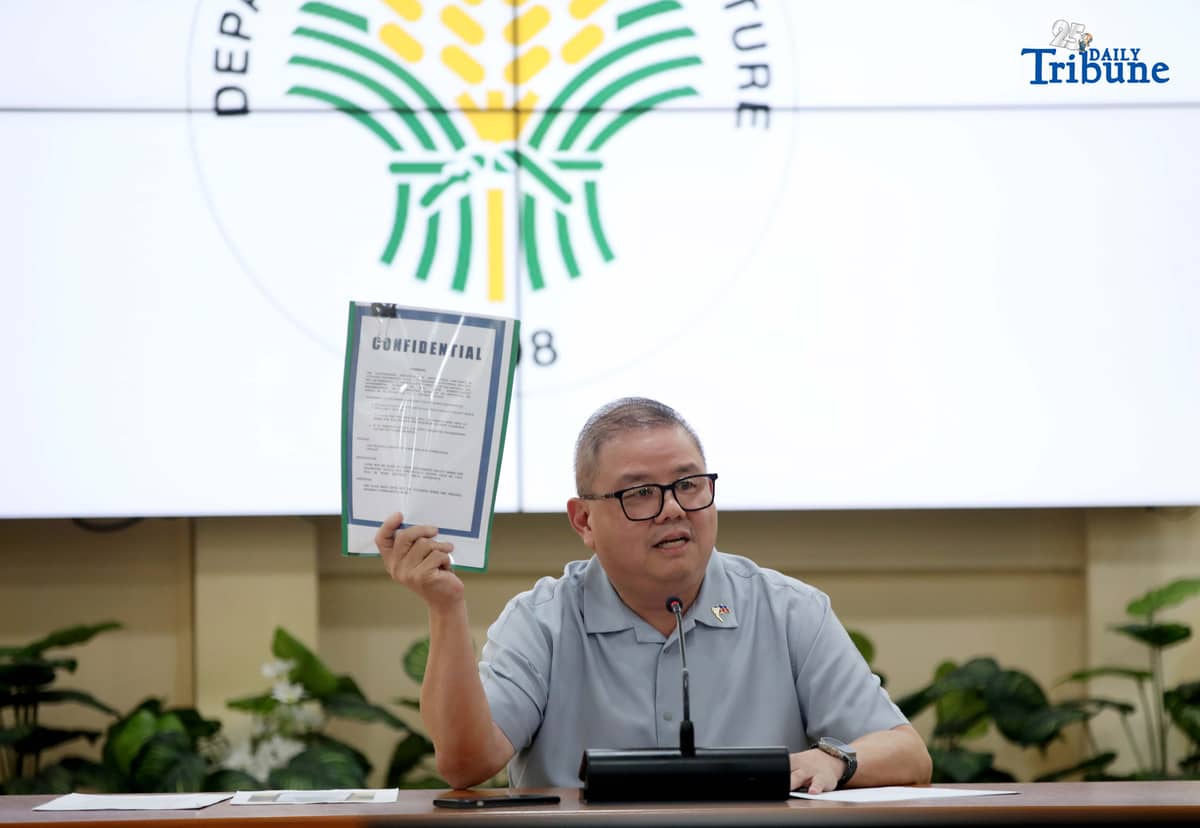 Agriculture Secretary Francisco Tiu Laurel Jr. shows a photocopy of his text exchange with former congressman Zaldy Co — along with a confidential report for Congress — in response to Co’s allegations of “price and import manipulation” of sugar, onion, rice, and fish. Tiu also denied claims that Co influenced the reduction of rice tariffs from 35 percent to 15 percent. The secretary refuted all accusations during a press conference at the Department of Agriculture office in Quezon City on Thursday. Photo by Analy Labor