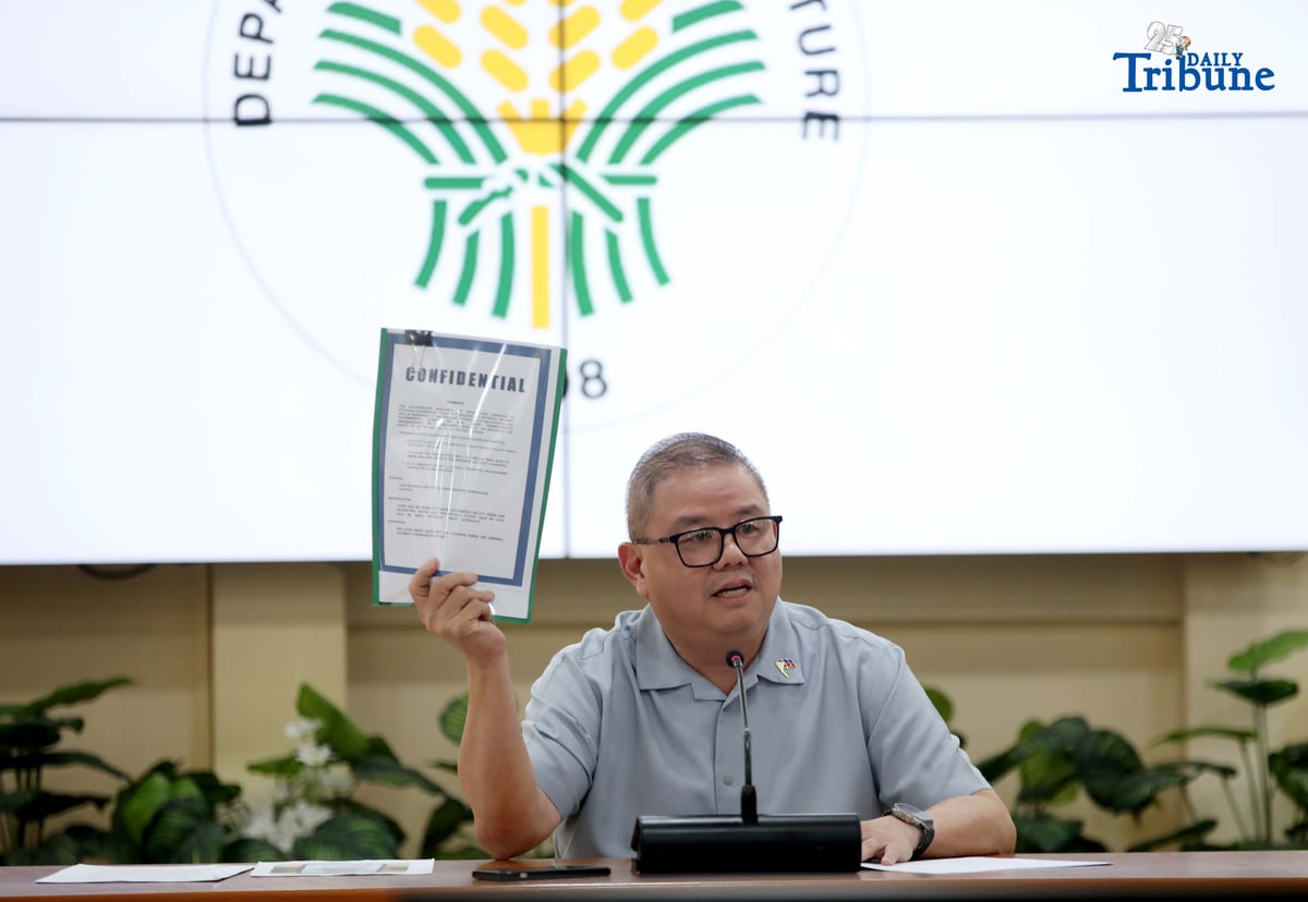 Agriculture Secretary Francisco Tiu Laurel Jr. shows a photocopy of his text exchange with former congressman Zaldy Co — along with a confidential report for Congress — in response to Co’s allegations of “price and import manipulation” of sugar, onion, rice, and fish. Tiu also denied claims that Co influenced the reduction of rice tariffs from 35 percent to 15 percent. The secretary refuted all accusations during a press conference at the Department of Agriculture office in Quezon City on Thursday. Photo by Analy Labor