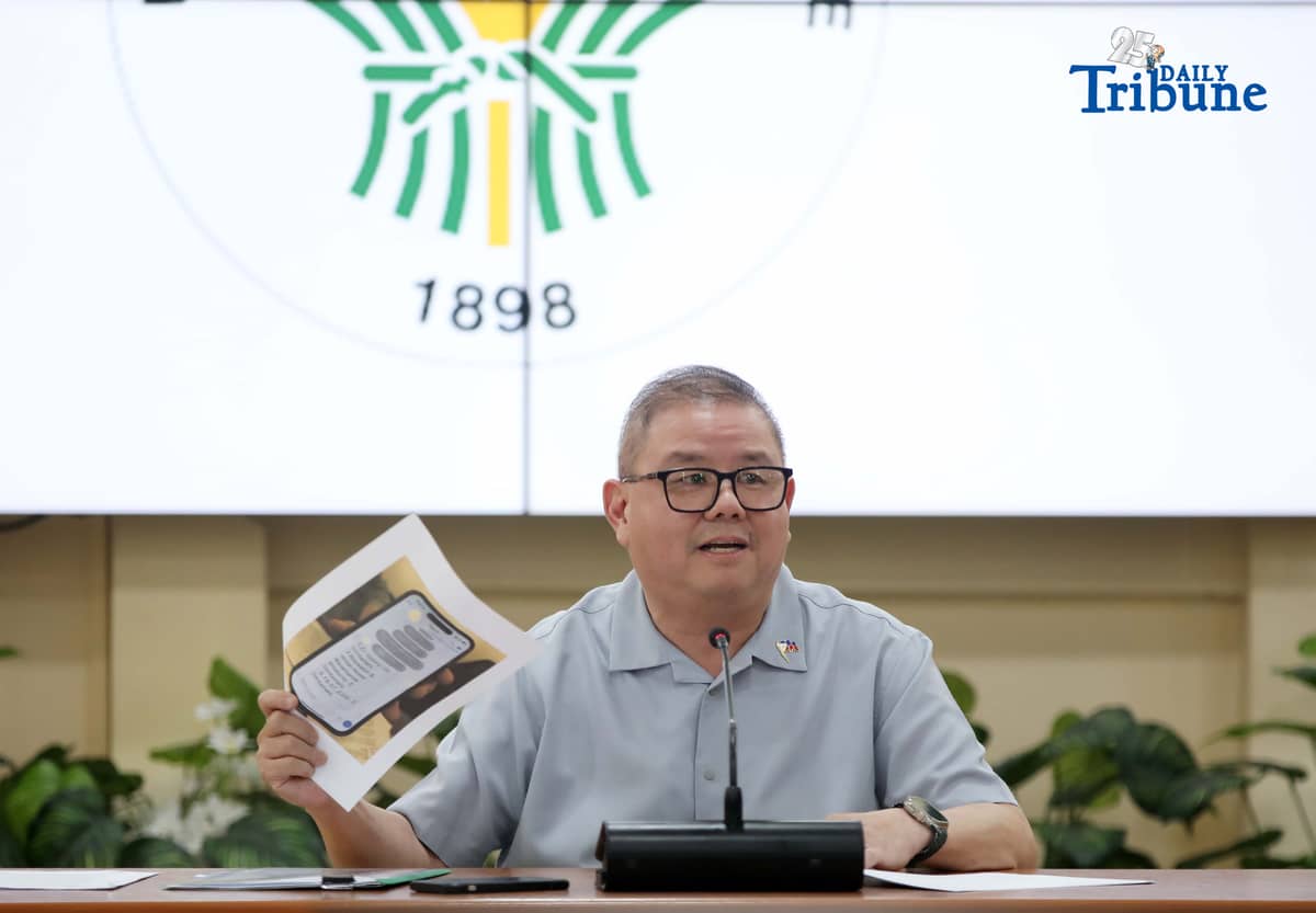 Agriculture Secretary Francisco Tiu Laurel Jr. shows a photocopy of his text exchange with former congressman Zaldy Co — along with a confidential report for Congress — in response to Co’s allegations of “price and import manipulation” of sugar, onion, rice, and fish. Tiu also denied claims that Co influenced the reduction of rice tariffs from 35 percent to 15 percent. The secretary refuted all accusations during a press conference at the Department of Agriculture office in Quezon City on Thursday. Photo by Analy Labor