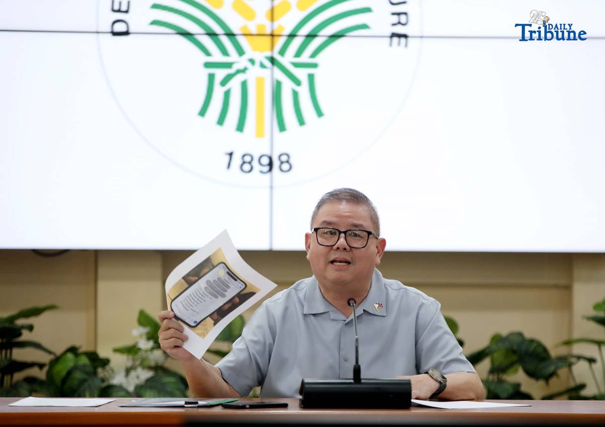 Agriculture Secretary Francisco Tiu Laurel Jr. shows a photocopy of his text exchange with former congressman Zaldy Co — along with a confidential report for Congress — in response to Co’s allegations of “price and import manipulation” of sugar, onion, rice, and fish. Tiu also denied claims that Co influenced the reduction of rice tariffs from 35 percent to 15 percent. The secretary refuted all accusations during a press conference at the Department of Agriculture office in Quezon City on Thursday. Photo by Analy Labor