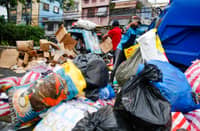 Piles of waste and garbage are being picked up by the workers from the local government of Manila’s environment department along Moriones Street in Tondo, Manila.