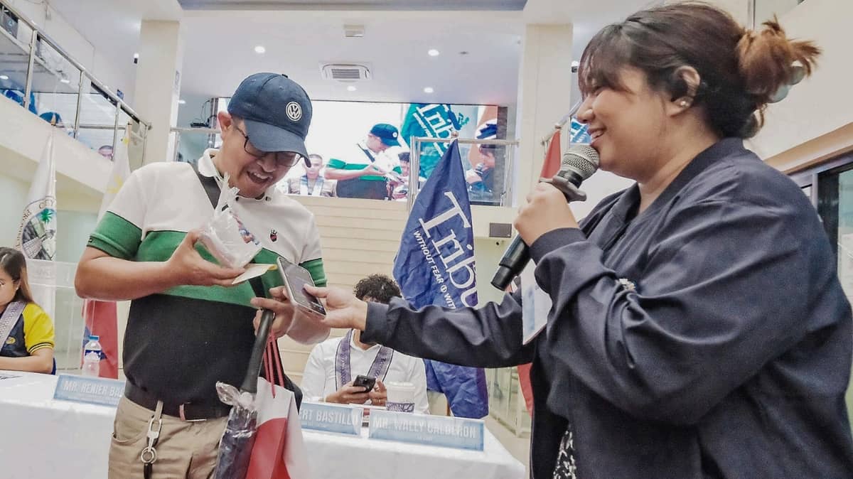 a Participant recevies his prize from AIF host Patricia Ramirez during the raffle segment of the program.