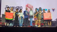 Denise van Dijk, president and chief executive officer of DKT Health Inc.; Joweeh B. Liao, director for the Health Business Unit, Finance, and Property Development at Watsons Philippines; and members of LGBTIQ+ organization UP Babaylan receive the plaque from Justin Patterson, an adjudicator from the Guinness World Records, for achieving the largest condom donation in one hour.