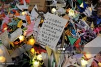Paper cranes and electric candles left by mourners are seen during a vigil held outside the Wang Fuk Court apartment blocks in the aftermath of the deadly November 26 fire in Hong Kong's Tai Po district on December 3, 2025. The death toll from Hong Kong's worst fire in decades rose to 159 after all affected housing blocks were searched, police said on December 3, cautioning that the figure may not be final.