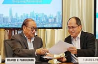 PEZA Director General Tereso O. Panga (right) and Meralco Chairman and CEO Manuel V. Pangilinan exchanges the memorandum of understanding after they affixed their signature, transpired last 3 December in Meralco headquarters in Pasig City.