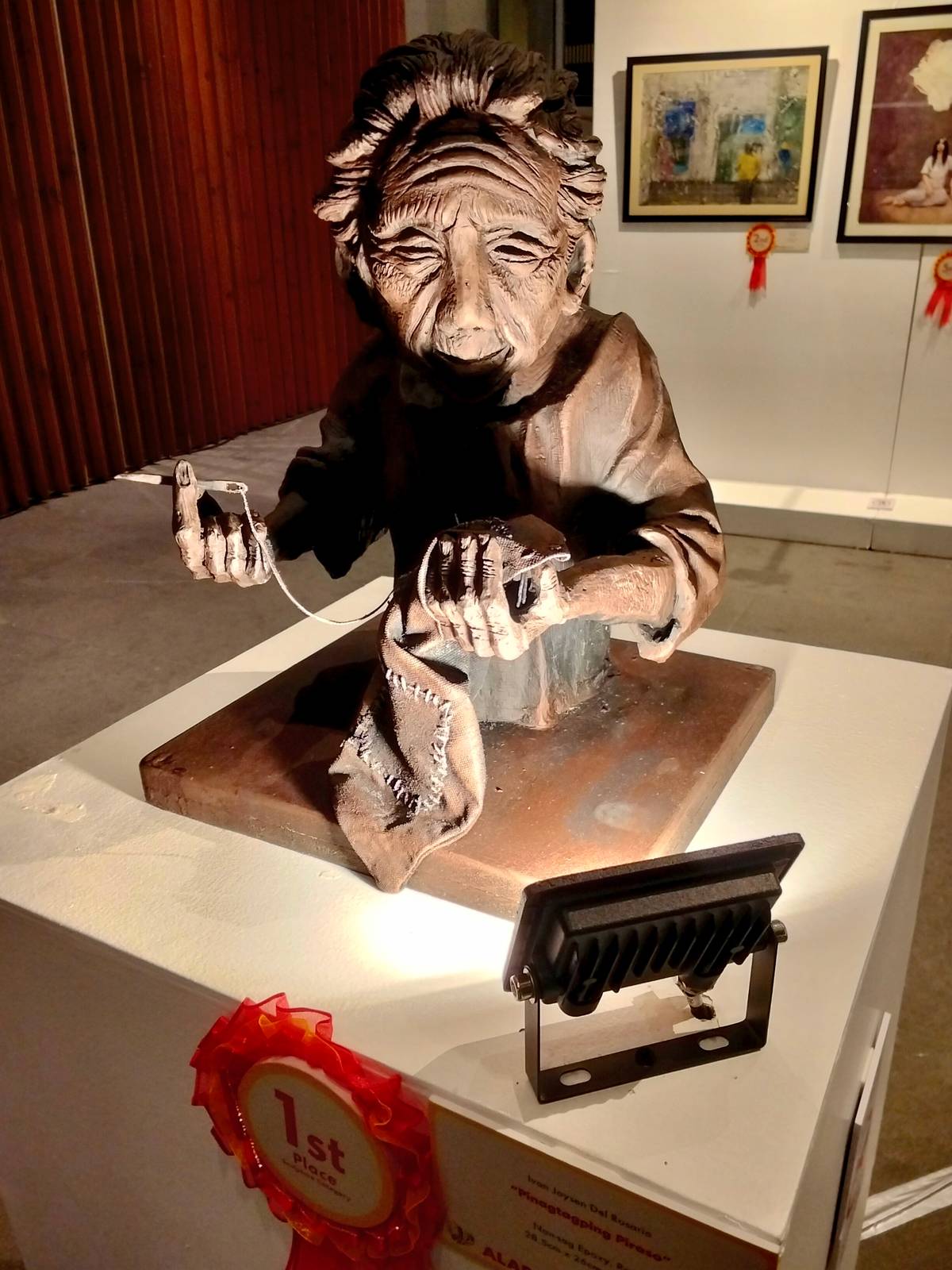 Nineteen-year-old Ivan Joysen Del Rosario won first place in the sculpture category with "Pinagtagping Piraso." This was his first-ever competition entry. He grew up watching his father’s sculpting and local art movements. He expressed gratitude and surprise at taking home the top prize.