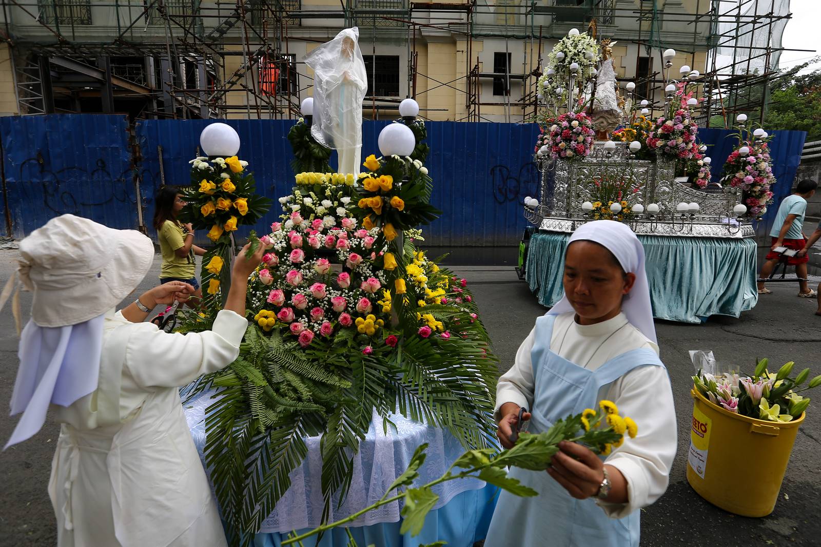 Members of the Sisters of Mary Congregation in Silang, Cavite, prepare their patroness, Our Lady of Banneux — also known as Our Lady of the Poor — by adorning her image ahead of the Grand Marian Procession in Intramuros, Manila, on Sunday afternoon, 07 December 2025.