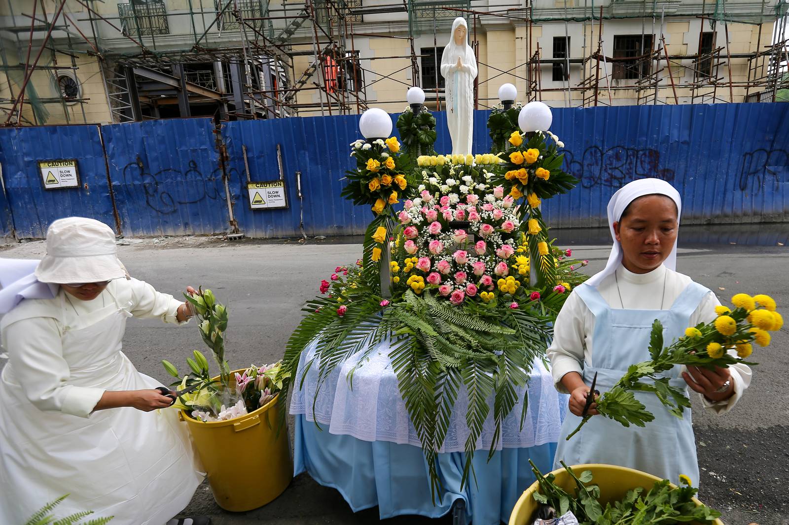 Members of the Sisters of Mary Congregation in Silang, Cavite, prepare their patroness, Our Lady of Banneux — also known as Our Lady of the Poor — by adorning her image ahead of the Grand Marian Procession in Intramuros, Manila, on Sunday afternoon, 07 December 2025.