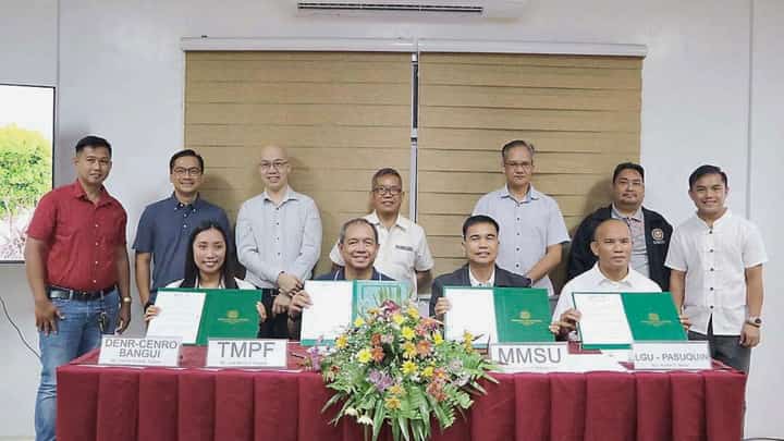 FORMALITIES mark the signing of the coastal forest conservation agreement among TMP Foundation, MMSU, DENR-CENRO Bangui, and the Pasuquin local government. Shown are: (from left, front) DENR-Community Environment and Natural Resources Office Bangui Ecosystem Management specialist I Justine Rose Teneza, TMP Foundation president Jose Maria Aligada, MMSU president Dr. Virgilio Julius Manzano Jr., and Municipal Government of Pasuquin Environmental Protection Committee chair Romel Ranay, together with other TMP network officers and MMSU officials, during the signing of the memorandum of agreement for the Coastal Forest Conservation Project.