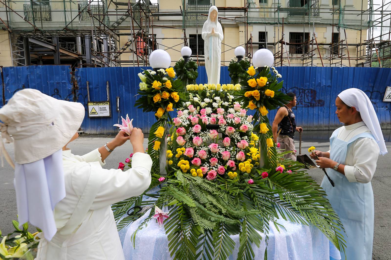 Members of the Sisters of Mary Congregation in Silang, Cavite, prepare their patroness, Our Lady of Banneux — also known as Our Lady of the Poor — by adorning her image ahead of the Grand Marian Procession in Intramuros, Manila, on Sunday afternoon, 07 December 2025.