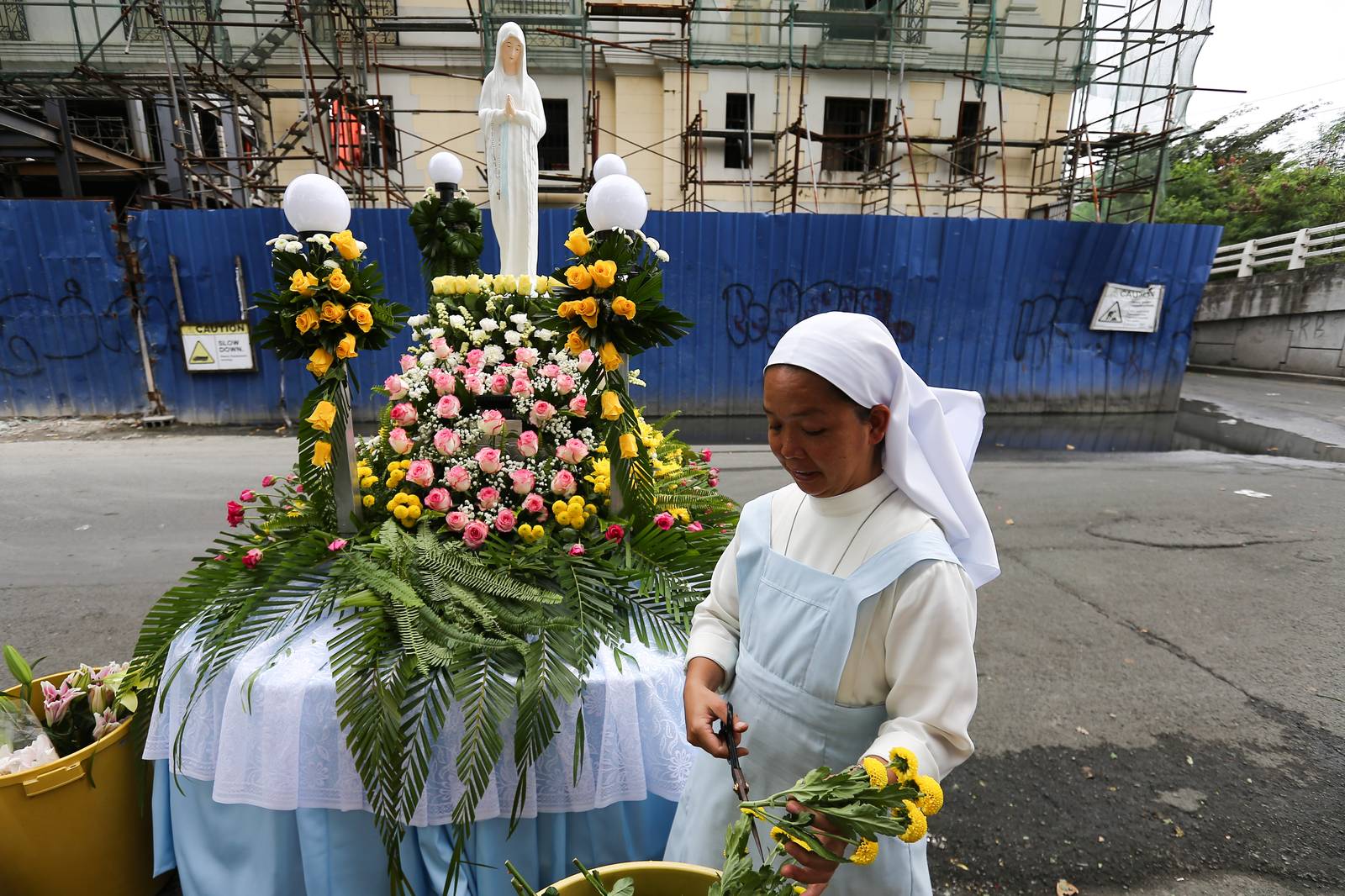Members of the Sisters of Mary Congregation in Silang, Cavite, prepare their patroness, Our Lady of Banneux — also known as Our Lady of the Poor — by adorning her image ahead of the Grand Marian Procession in Intramuros, Manila, on Sunday afternoon, 07 December 2025.