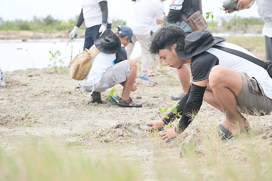 TEAM members gather at the Davila coastal site after completing the seedling planting activity.