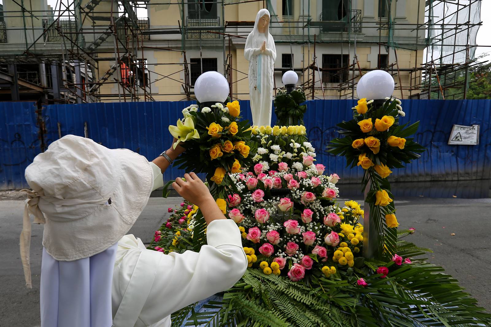 Members of the Sisters of Mary Congregation in Silang, Cavite, prepare their patroness, Our Lady of Banneux — also known as Our Lady of the Poor — by adorning her image ahead of the Grand Marian Procession in Intramuros, Manila, on Sunday afternoon, 07 December 2025.