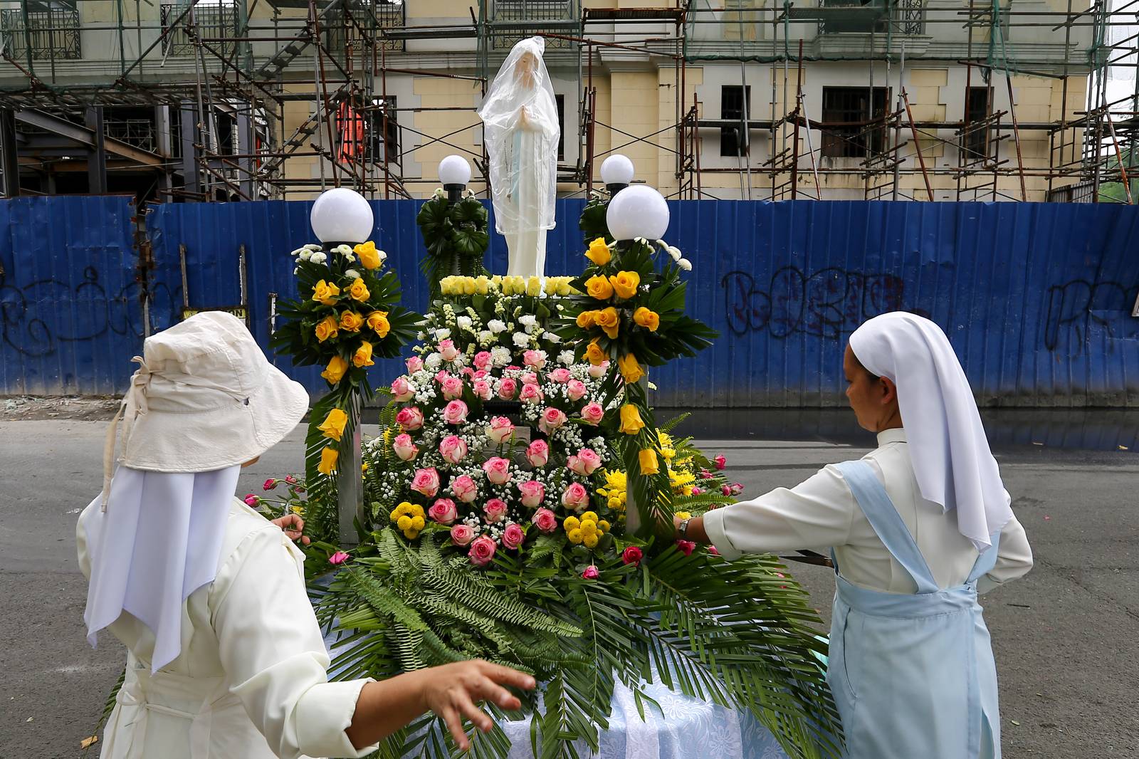 Members of the Sisters of Mary Congregation in Silang, Cavite, prepare their patroness, Our Lady of Banneux — also known as Our Lady of the Poor — by adorning her image ahead of the Grand Marian Procession in Intramuros, Manila, on Sunday afternoon, 07 December 2025.