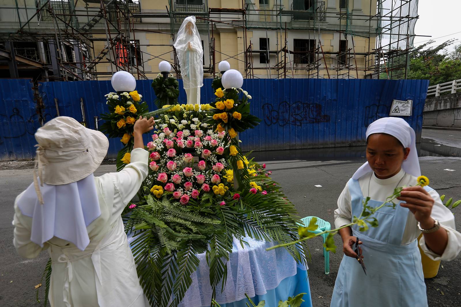 Members of the Sisters of Mary Congregation in Silang, Cavite, prepare their patroness, Our Lady of Banneux — also known as Our Lady of the Poor — by adorning her image ahead of the Grand Marian Procession in Intramuros, Manila, on Sunday afternoon, 07 December 2025.
