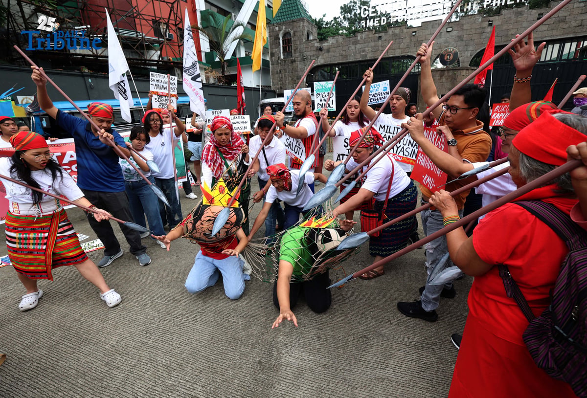 Militant and Indigenous groups stage a protest along EDSA outside Camp Aguinaldo in Quezon City on Monday, December 8, 2025, to mark Indigenous Peoples and Moro Human Rights Day. The groups called for action on alleged intensifying human rights violations, corruption scandals, and the funneling of AFP, NTF-ELCAC, and Barangay Development Program funds into militarization and CAFGU operations—amid rising reports of enforced disappearances, killings and political persecution.