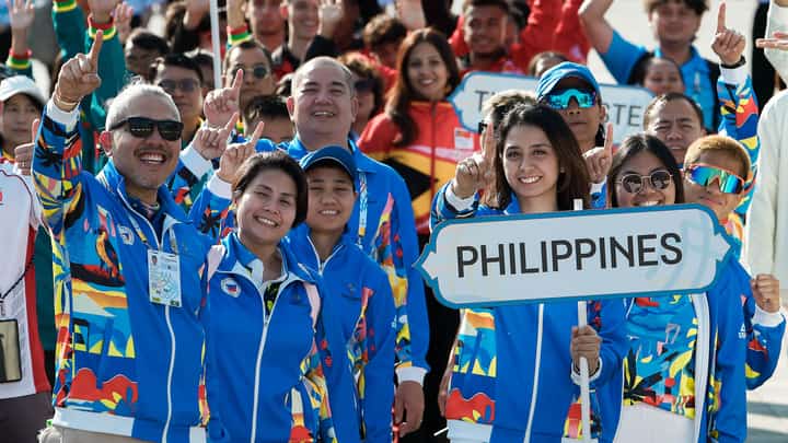 MEMBERS of the national team cheer as they raise the Philippine flag for the first time, signaling their readiness to compete for pride and glory in the 33rd Southeast Asian Games in Bangkok that will formally open on Tuesday evening at the Rajamangala National Stadium.