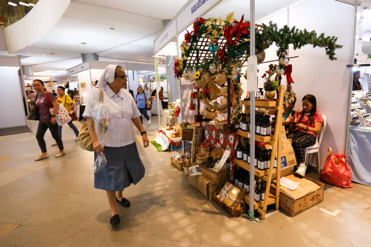 A NUN looking at rattan baskets and wreaths.