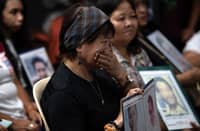 Families of Duterte’s drug war victims watch his first ICC appearance since his 11 March arrest during a live stream at a Manila church on 14 March 2025.