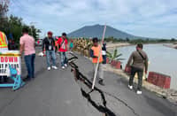 WORKERS from the Department of Public Works and Highways inspect the damaged section of the Cupang Dike in Barangay Cupang, Arayat recently.