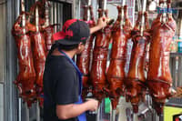 December 10 2025) Workers were seen cooking and displaying roasted pigs or Lechon at their shops in La Loma , Quezon City, on Wednesday December 10 2025, following the recent closure due to the African-swine fever, they are now slowly starting to regain its festive atmosphere. Laloma is the lechon capital of the Philippines. Photo/Analy Labor
