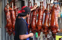 December 10 2025) Workers were seen cooking and displaying roasted pigs or Lechon at their shops in La Loma , Quezon City, on Wednesday December 10 2025, following the recent closure due to the African-swine fever, they are now slowly starting to regain its festive atmosphere. Laloma is the lechon capital of the Philippines. Photo/Analy Labor